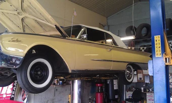 Classic convertible raised on the lift for service