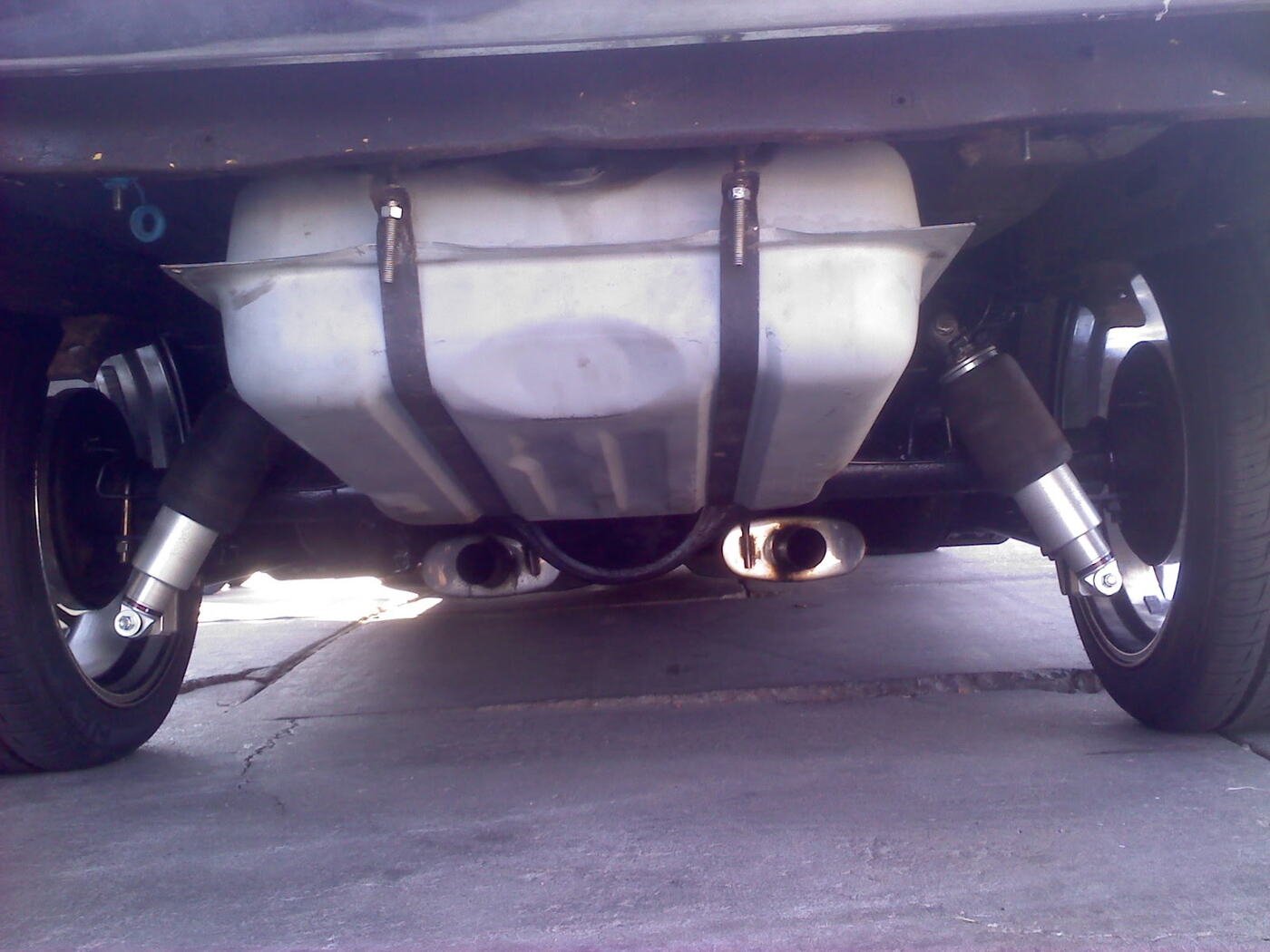 Custom dual exhaust tips viewed from underneath a car