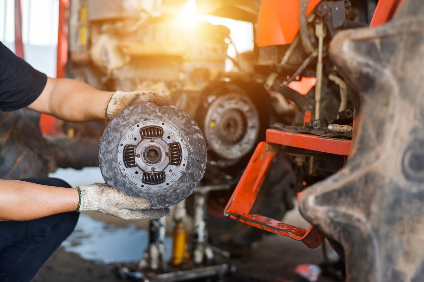 Mechanic inspecting a clutch plate during a repair