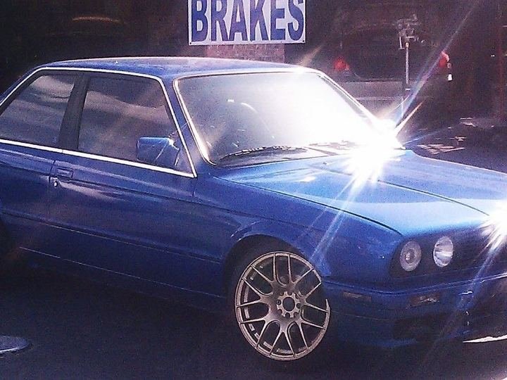 Blue coupe fitted with custom wheels