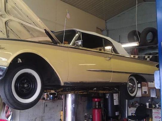 Classic convertible raised on the lift for service