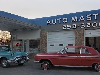 Front of the Auto Masters shop building with signage
