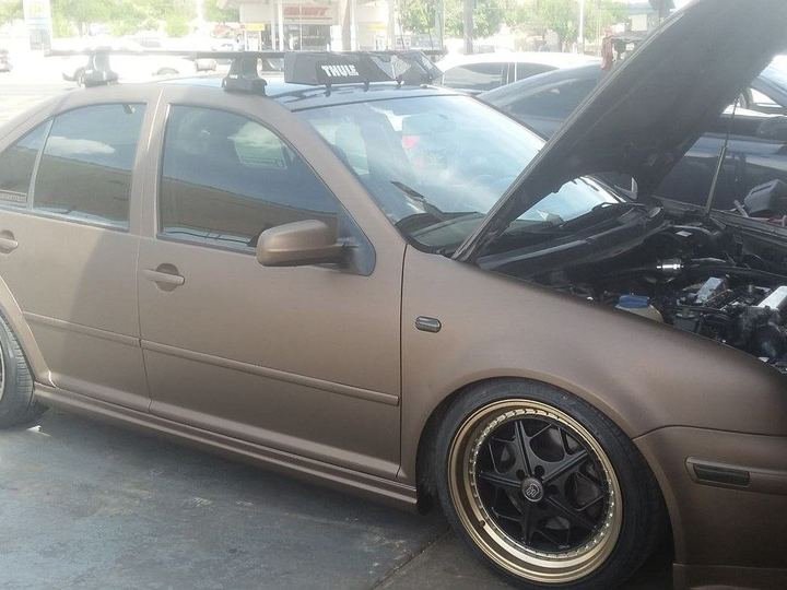 Matte bronze hatchback fitted with custom wheels