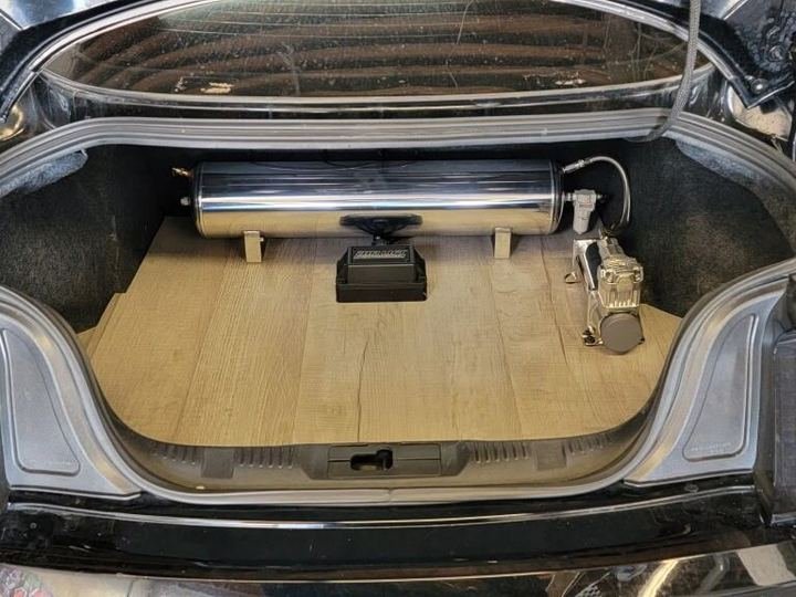 Trunk setup with a polished air ride tank and compressor