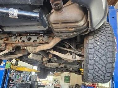 Undercarriage and exhaust work on a lift