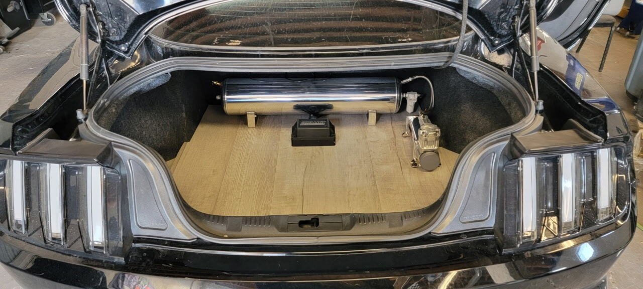 Trunk setup with a polished air ride tank and compressor